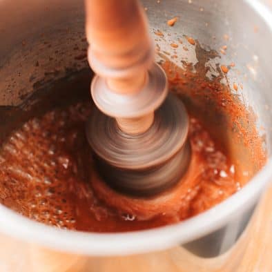 Traditional Mexican chocolate being ground for hot chocolate.