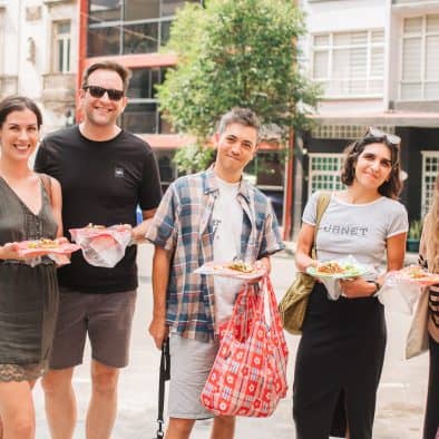 Vibrant group enjoying local food in Juarez during a food tour.