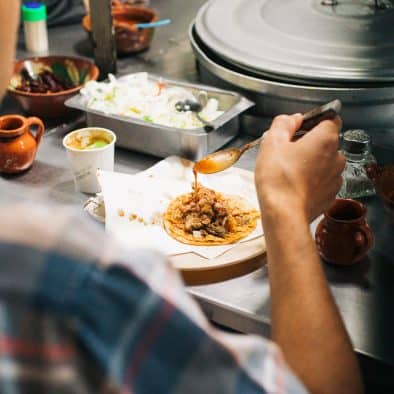Tasting traditional Juarez dishes during a food tour experience.