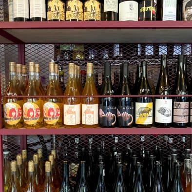 Wine & Street Food pairing with local wines and snacks in a vibrant street setting.