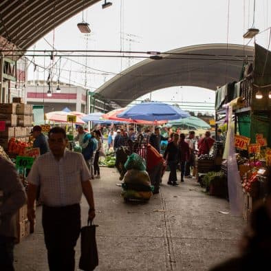 Market scene at Central de Abastos, a bustling food wholesale market in Mexico.